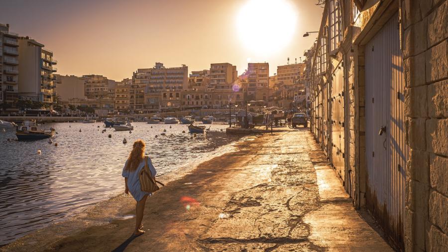 A woman walking by the sea in Malta
